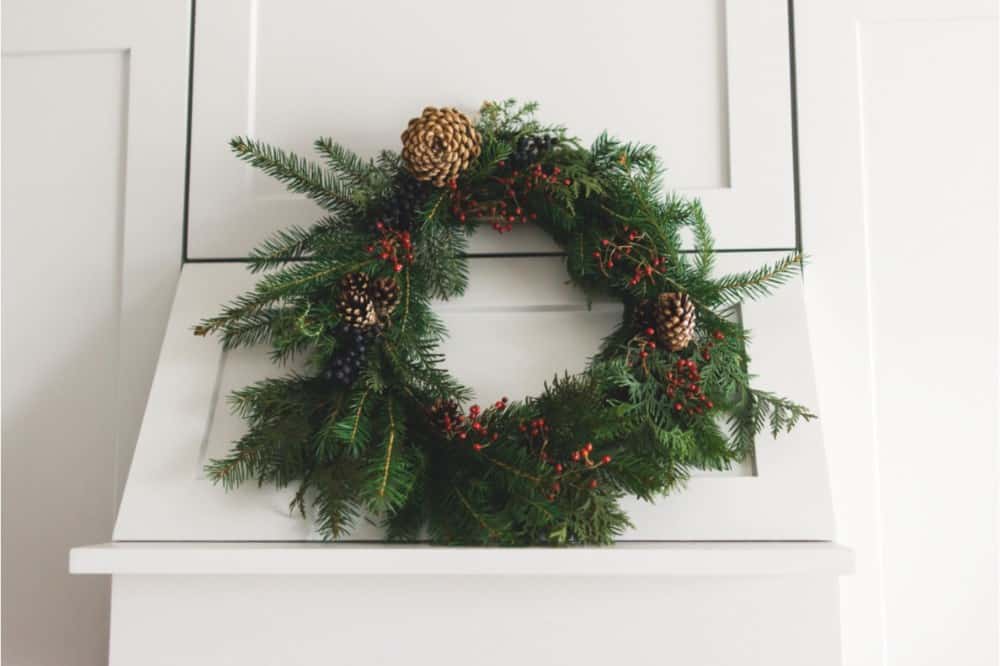 A Christmas wreath hanging on a kitchen hood